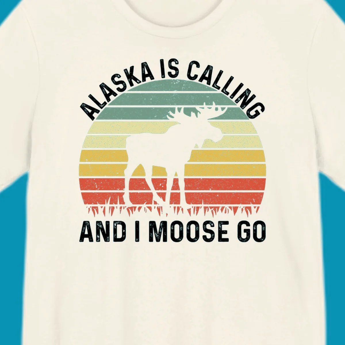 Distressed Alaska calling moose go design with moose and fish silhouettes against striped landscape layers in teal, yellow, and red