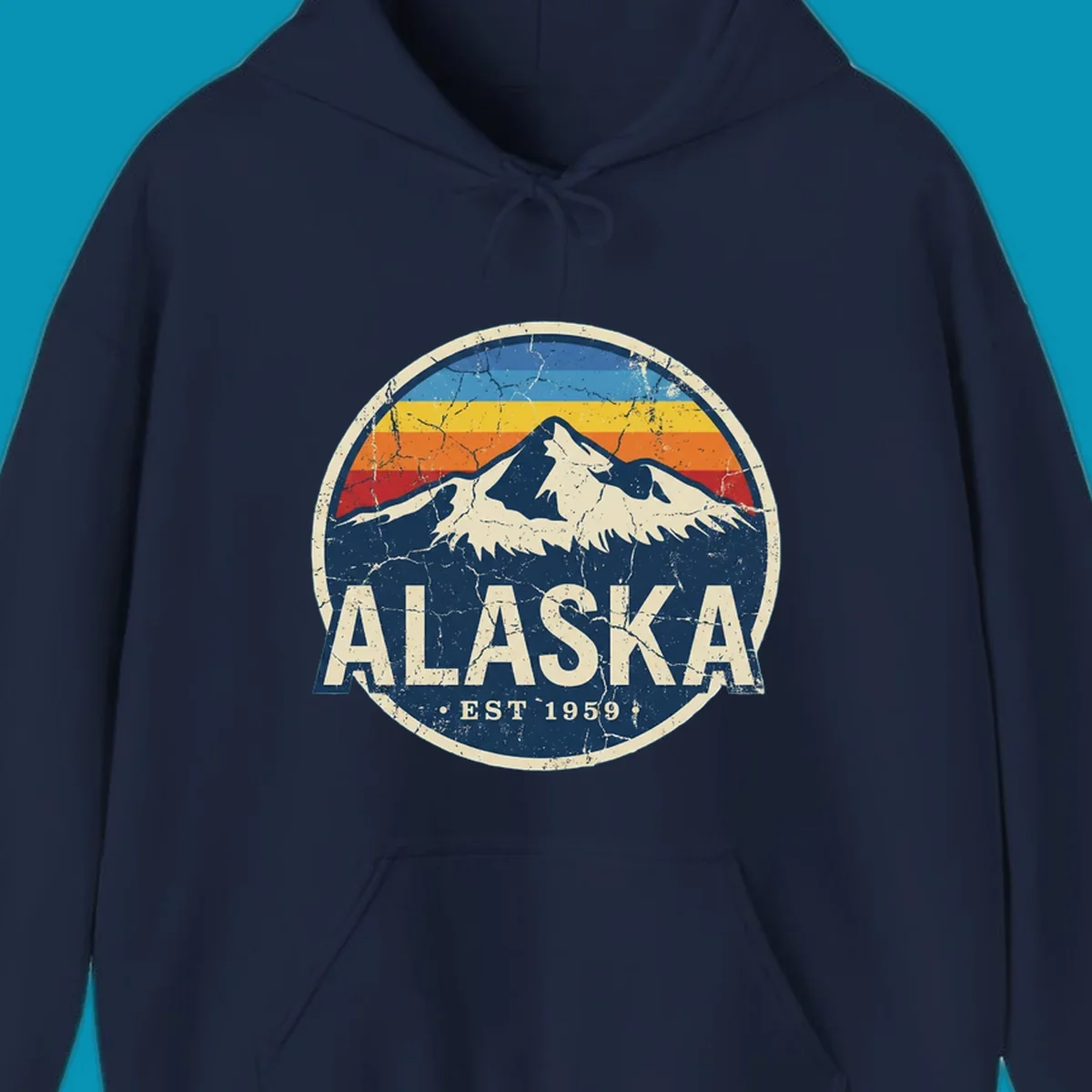 Vintage circular badge with snow-capped Alaska mountain, retro rainbow stripes, and distressed cream border featuring 'ALASKA EST 1959' text