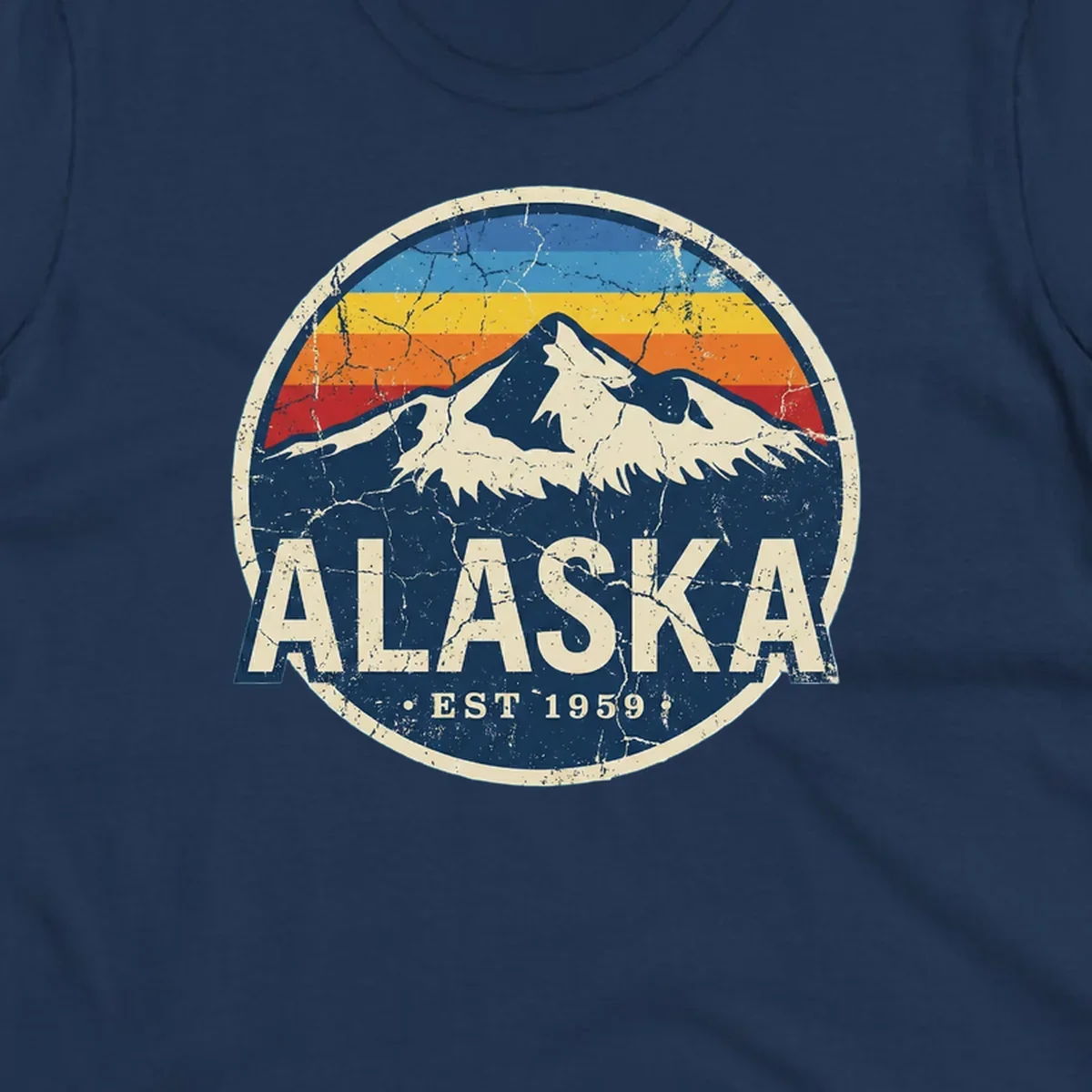 Vintage circular badge with snow-capped Alaska mountain, retro rainbow stripes, and distressed cream border featuring 'ALASKA EST 1959' text