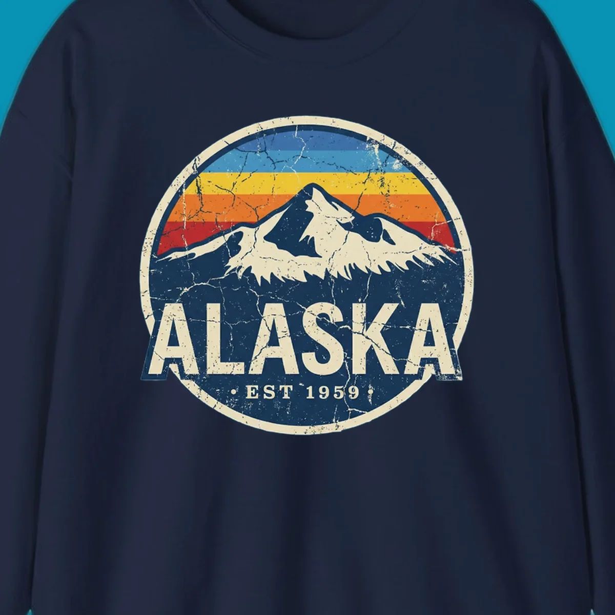 Vintage circular badge with snow-capped Alaska mountain, retro rainbow stripes, and distressed cream border featuring 'ALASKA EST 1959' text