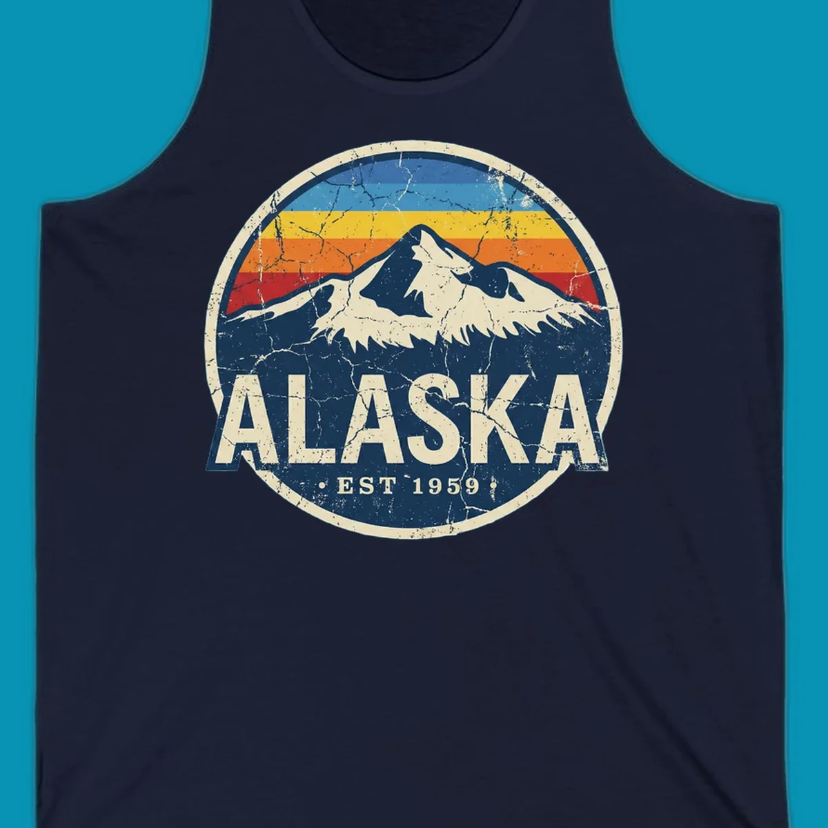 Vintage circular badge with snow-capped Alaska mountain, retro rainbow stripes, and distressed cream border featuring 'ALASKA EST 1959' text