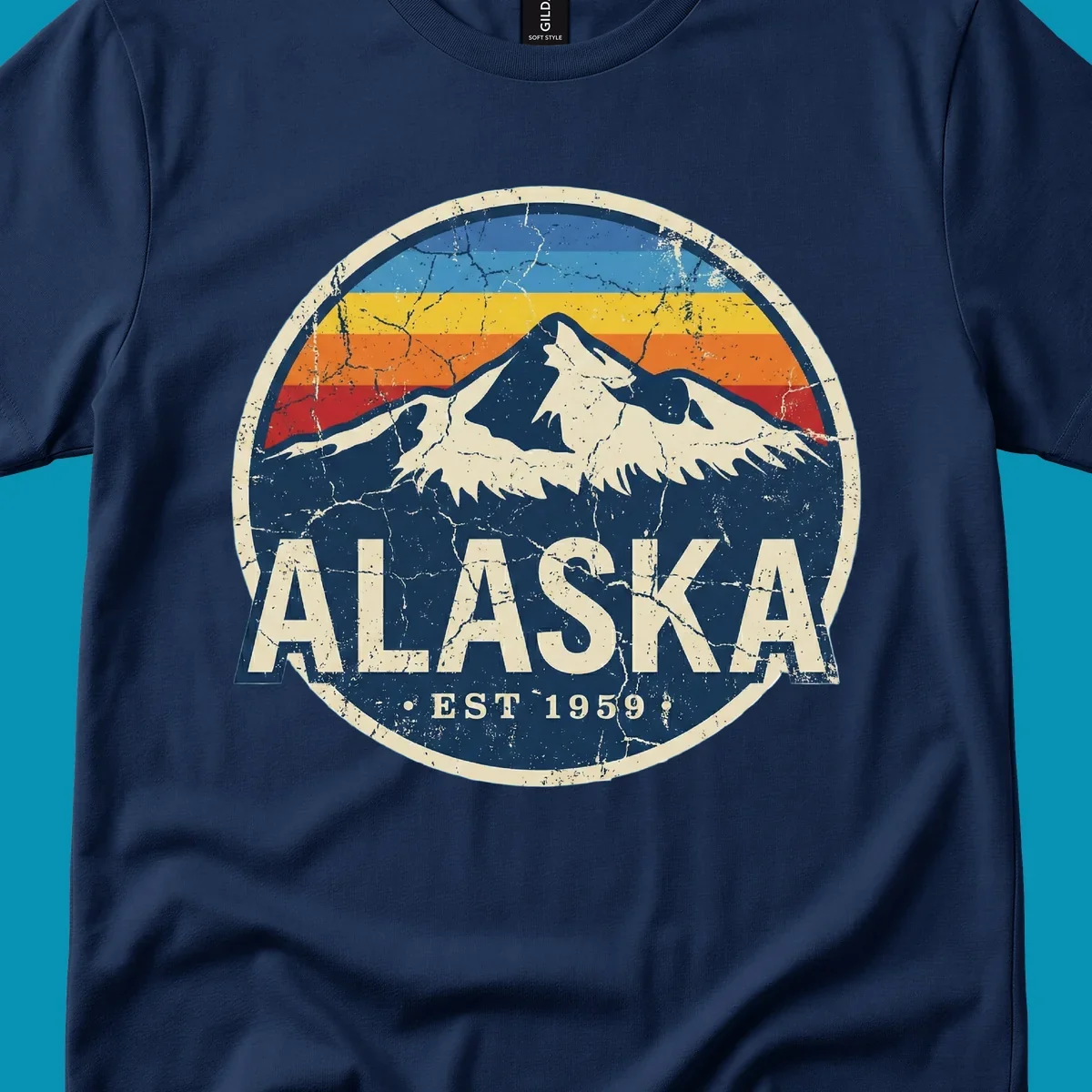 Vintage circular badge with snow-capped Alaska mountain, retro rainbow stripes, and distressed cream border featuring 'ALASKA EST 1959' text