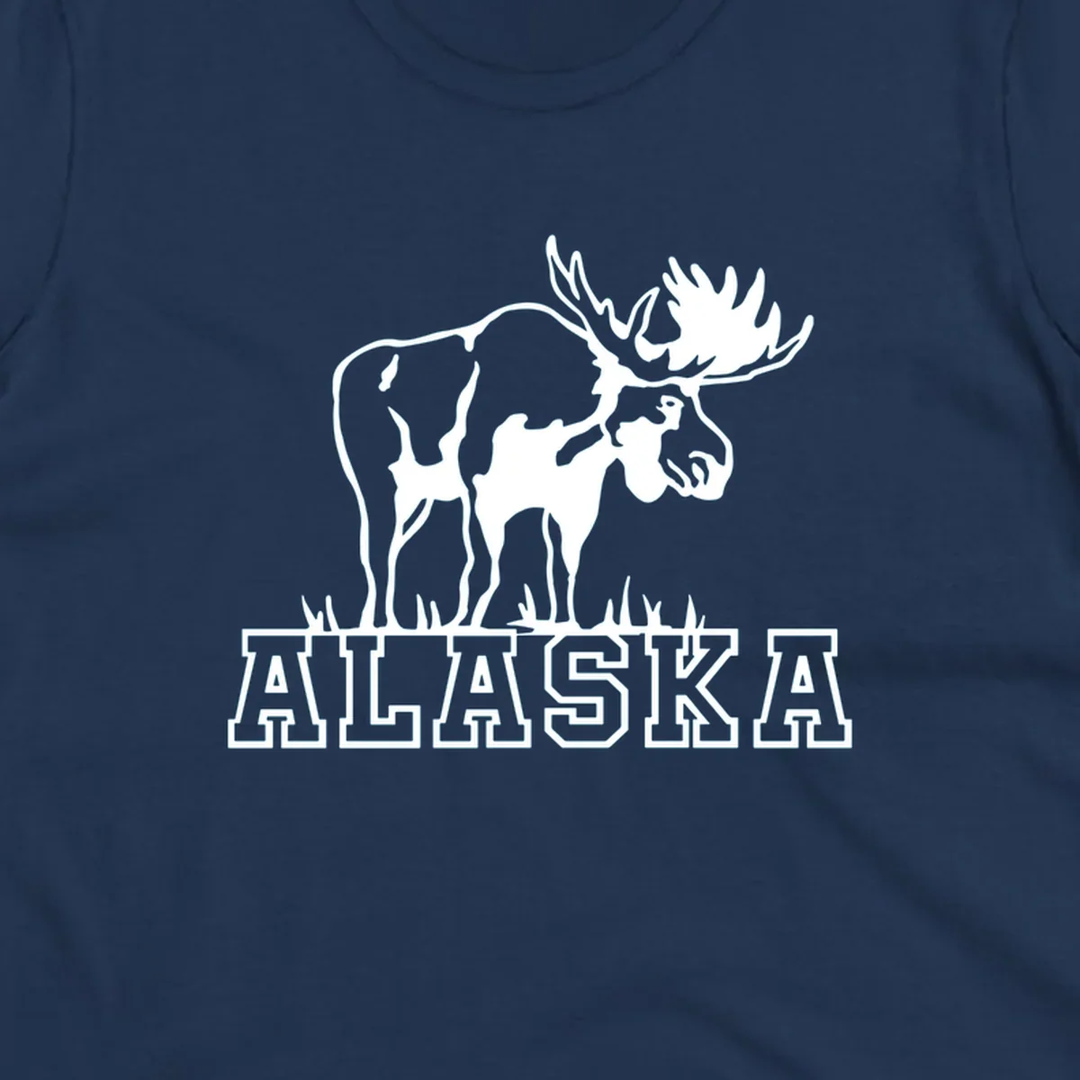 White silhouette of a majestic moose with large antlers standing with grass below and ALASKA text, moose-alaska-silhouette design