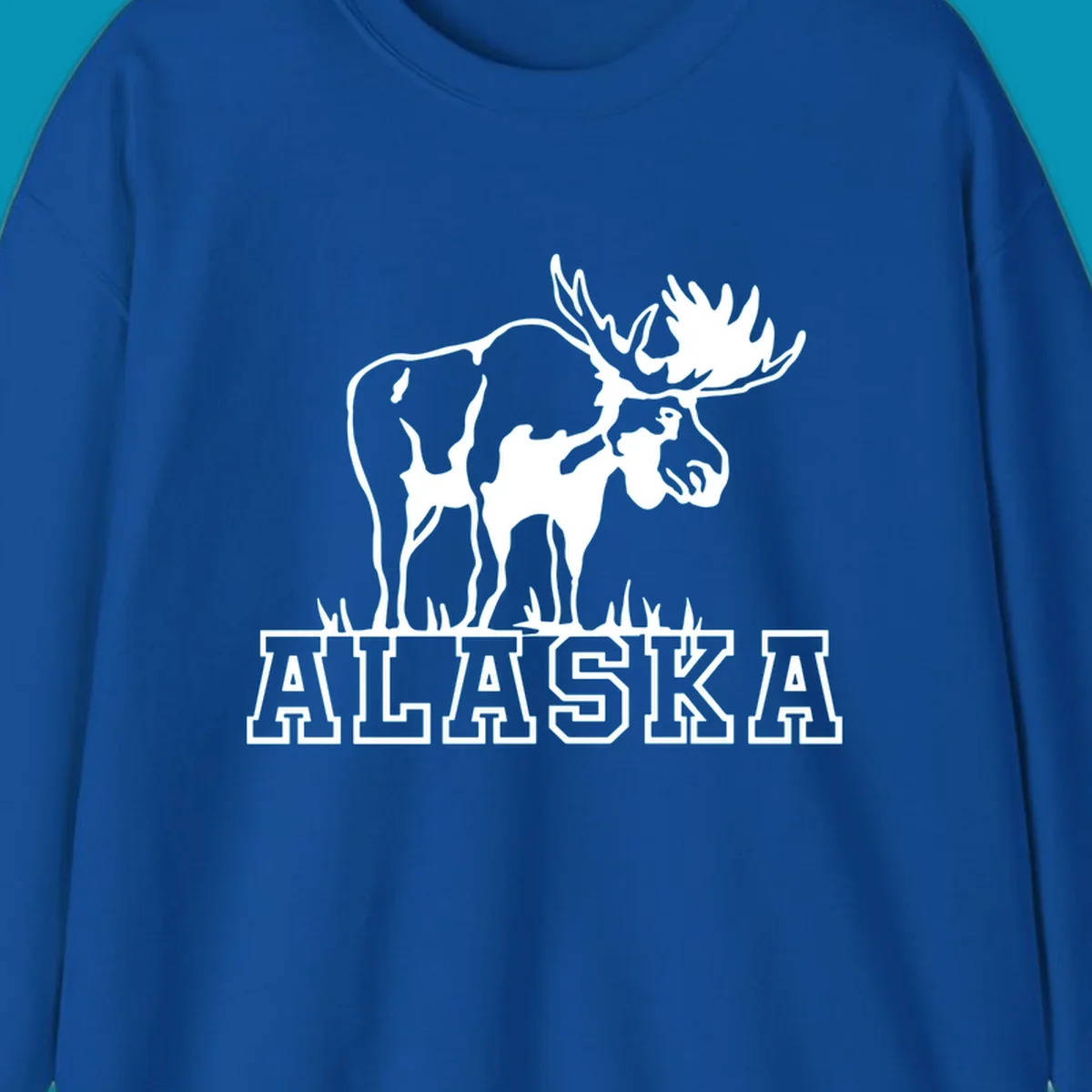 White silhouette of a majestic moose with large antlers standing with grass below and ALASKA text, moose-alaska-silhouette design