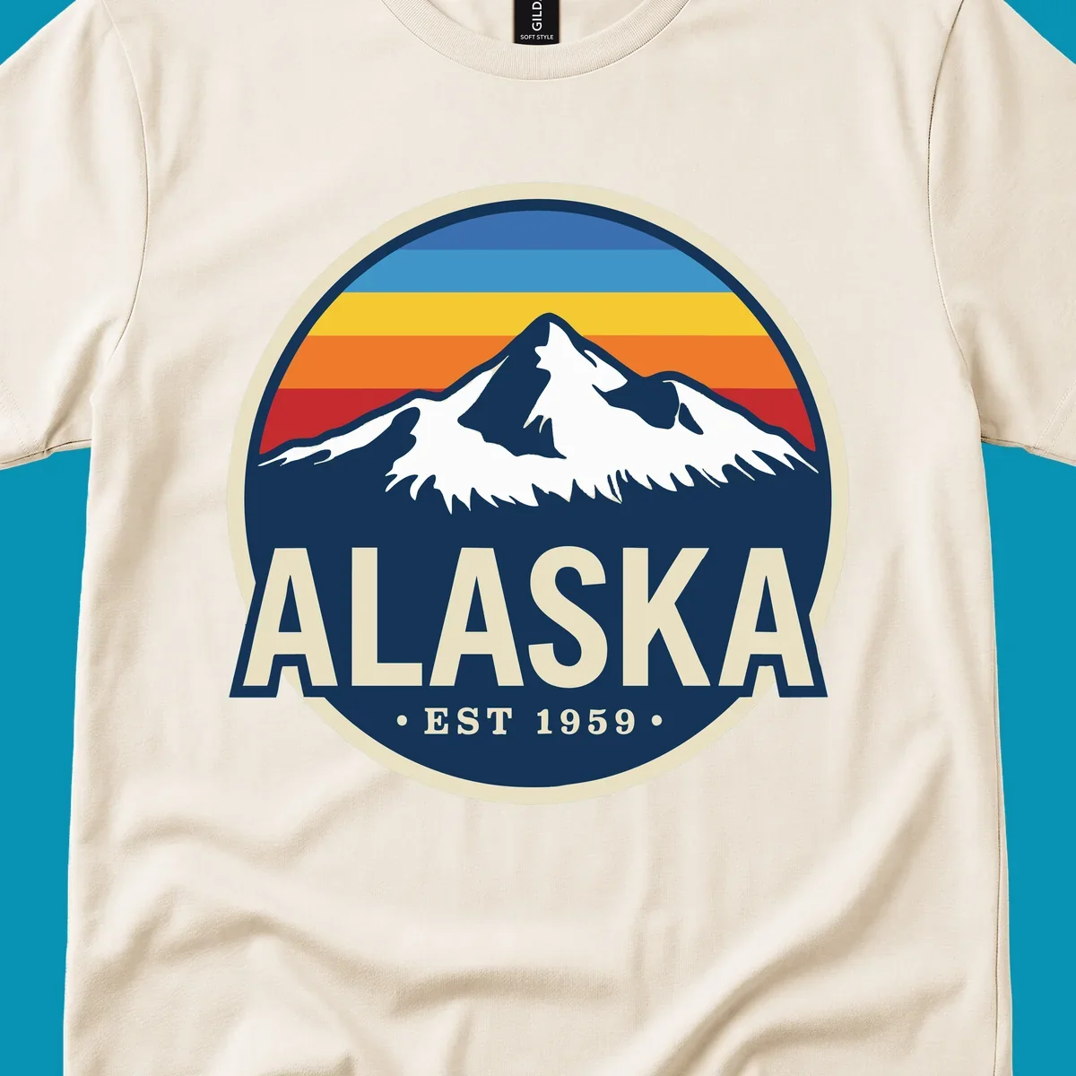 A circular alaska-mountain-range-sunset-badge design with retro stripes and white peaks above bold Alaska text.