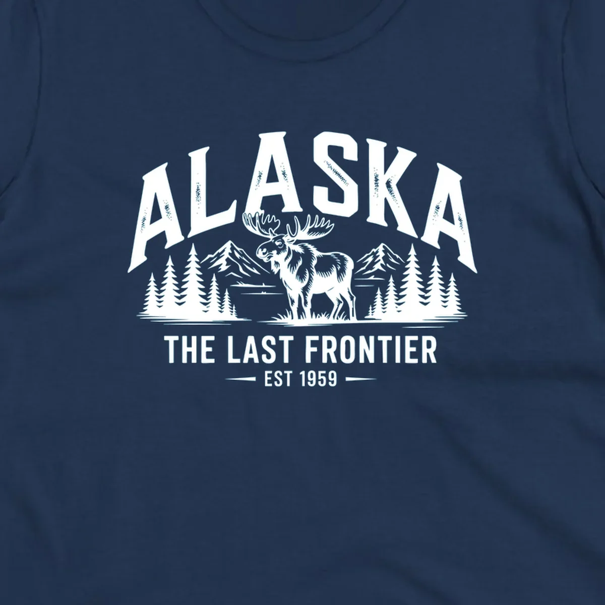 A white alaska-moose-frontier-scenic graphic showing a moose standing in front of mountains and pine trees.
