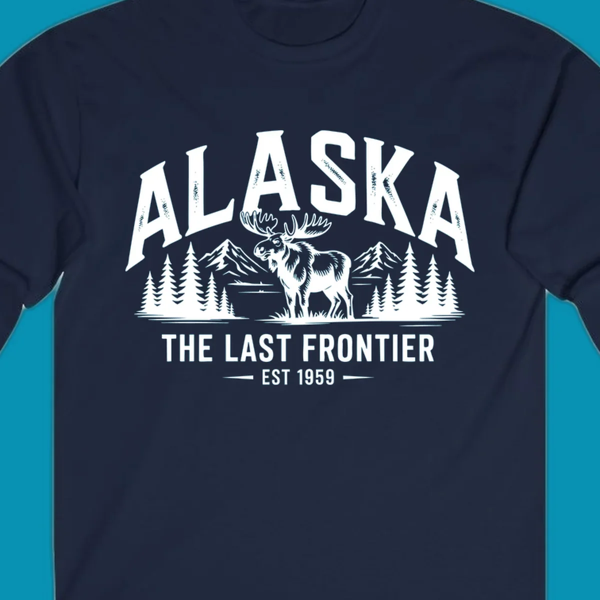 A white alaska-moose-frontier-scenic graphic showing a moose standing in front of mountains and pine trees.