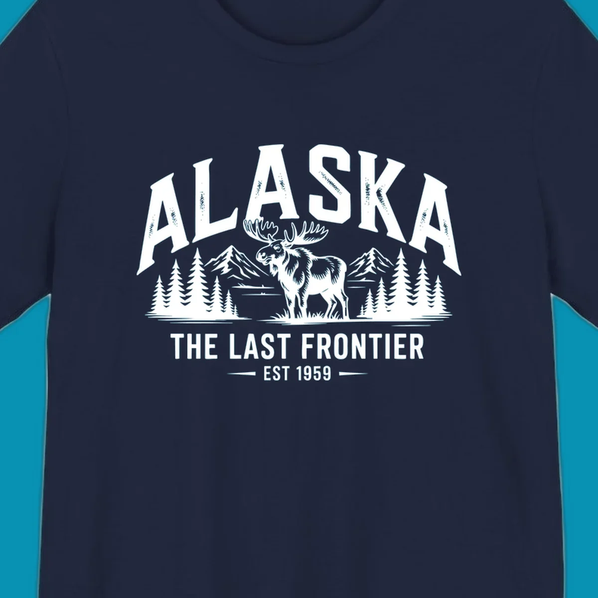 A white alaska-moose-frontier-scenic graphic showing a moose standing in front of mountains and pine trees.