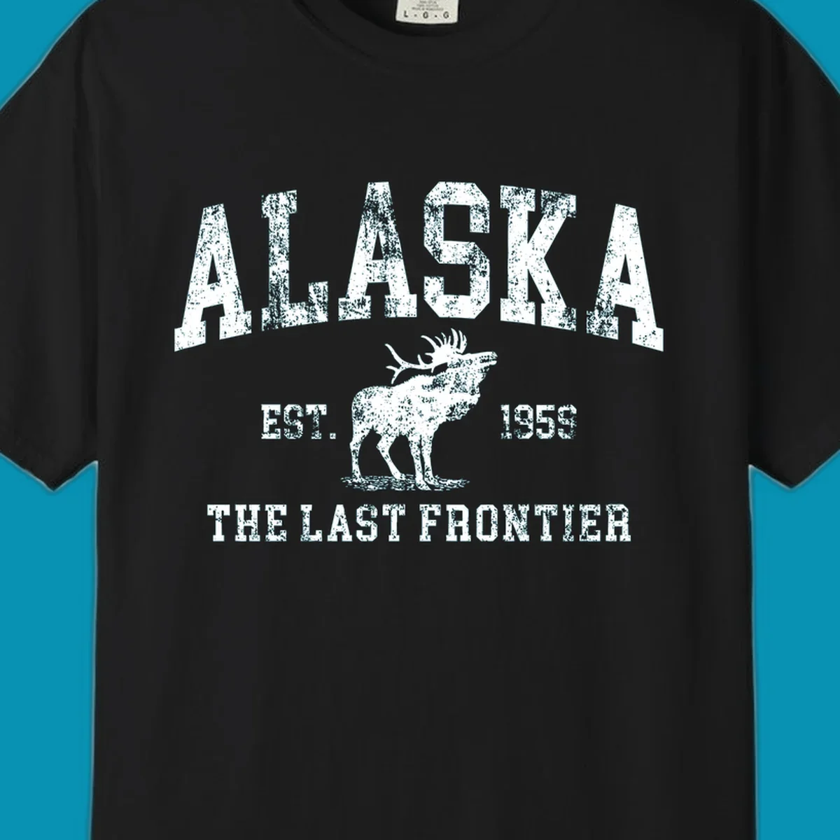 Distressed white design featuring a moose and the text ALASKA THE LAST FRONTIER.