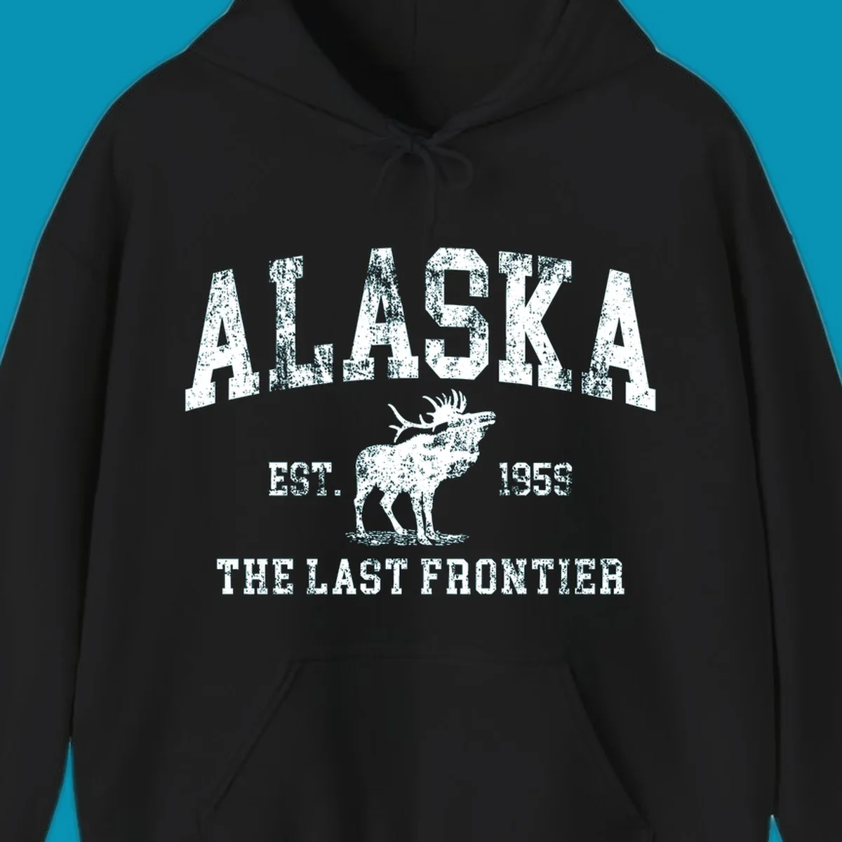 Distressed white design featuring a moose and the text ALASKA THE LAST FRONTIER.