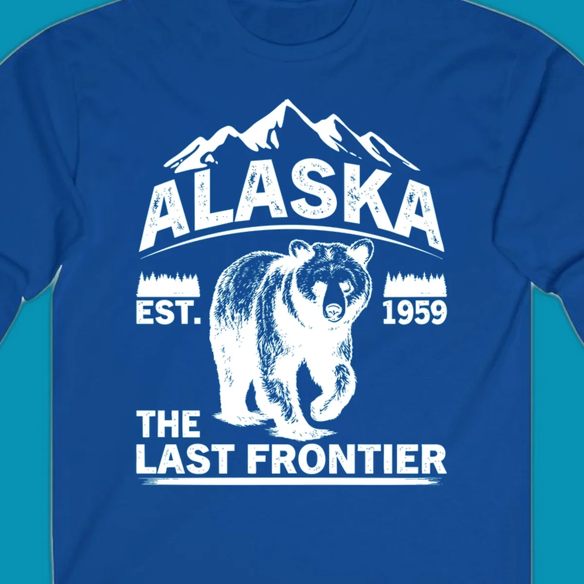 White graphic of a walking grizzly bear under mountain peaks with alaska-grizzly-frontier-mountains text.