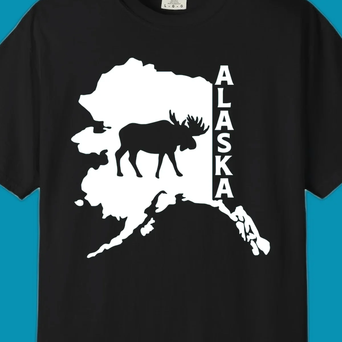 Bold white Alaska state map silhouette featuring a black moose and vertical ALASKA text.