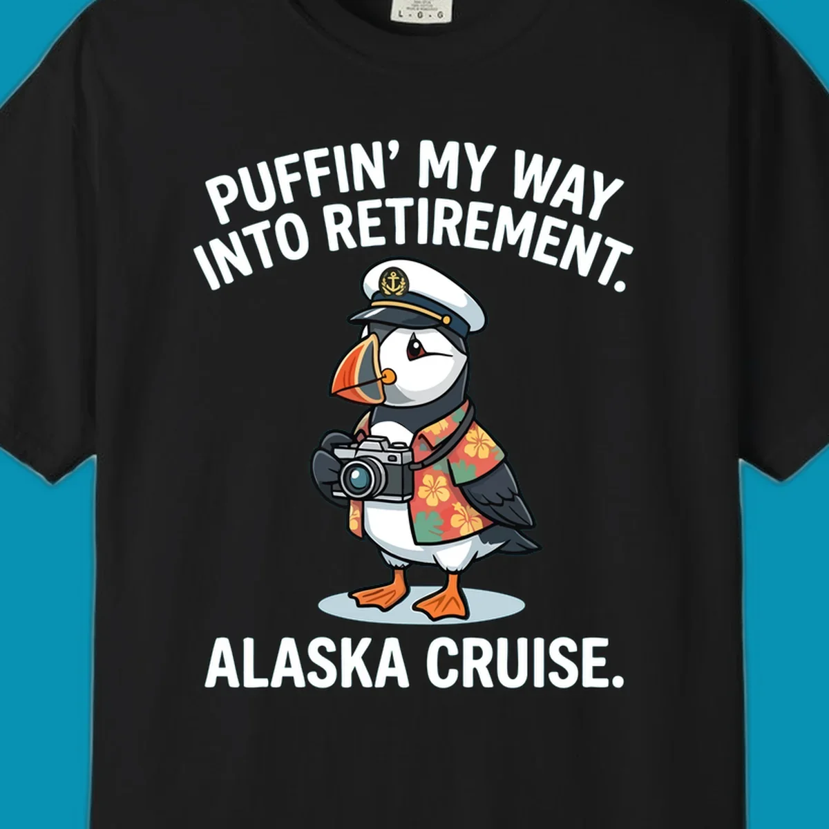 A cartoon puffin wearing a captain's hat and Hawaiian shirt holds a camera, with text 'PUFFIN' INTO MY RETIREMENT. ALASKA CRUISE.' for a puffin-into-retirement-cruise.