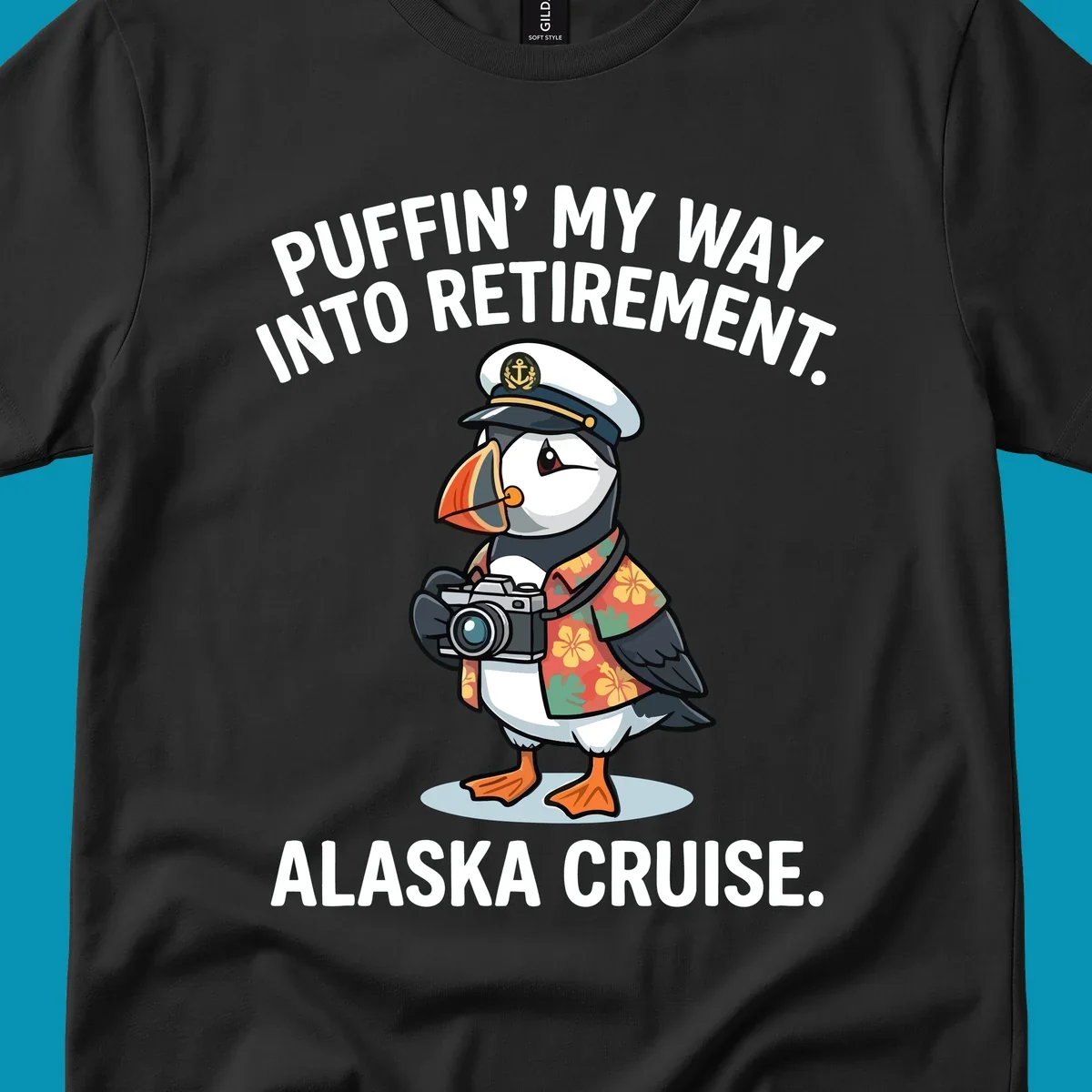 A cartoon puffin wearing a captain's hat and Hawaiian shirt holds a camera, with text 'PUFFIN' INTO MY RETIREMENT. ALASKA CRUISE.' for a puffin-into-retirement-cruise.