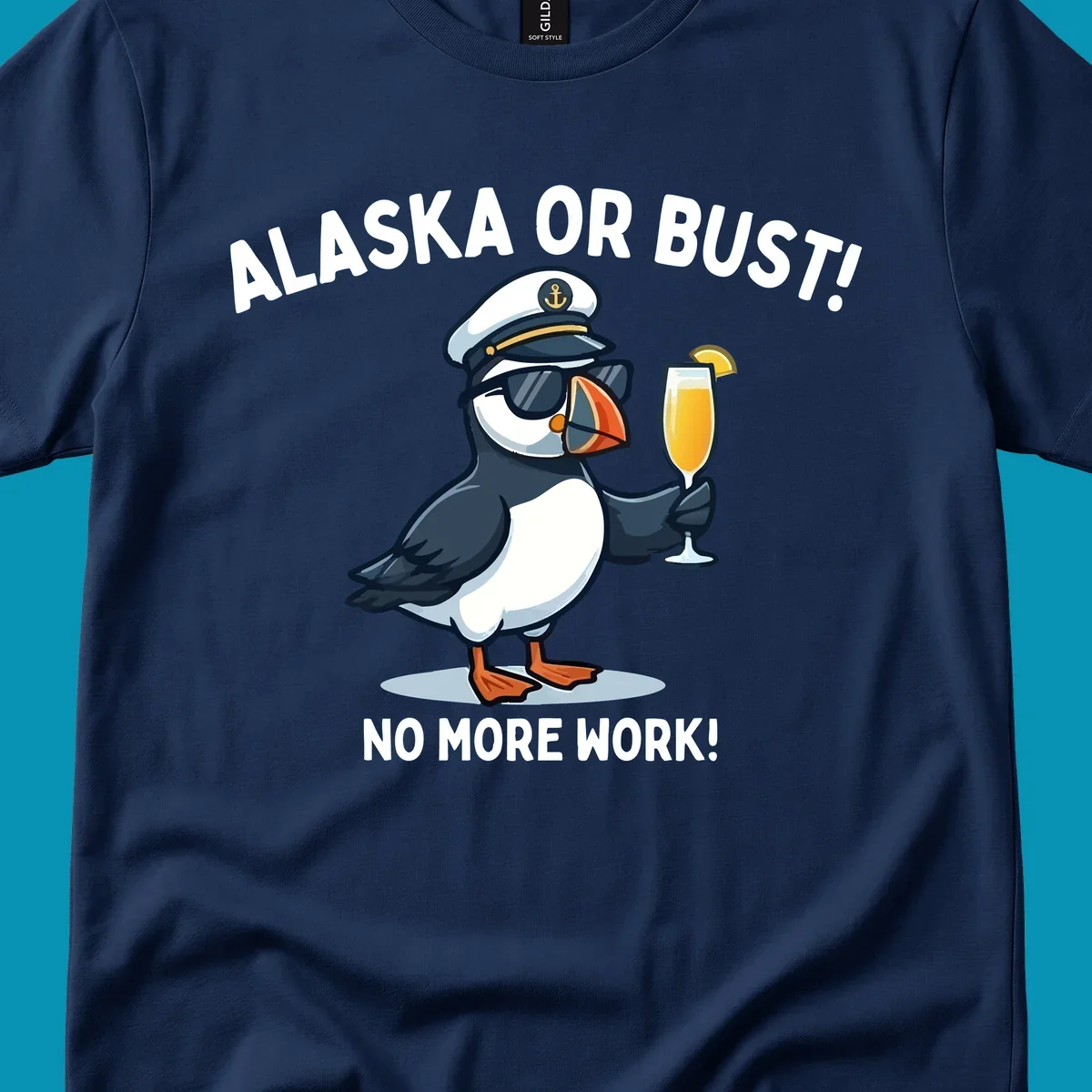 An illustrated puffin captain in sunglasses and a hat holds a cocktail with a lemon slice, with 'ALASKA OR BUST!' and 'NO MORE WORK!' text, representing the alaska-or-bust-captain-puffin concept.