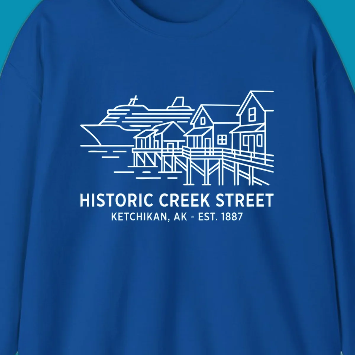 White line art illustration of Historic Creek Street in Ketchikan, Alaska, with a cruise ship, waterfront buildings, and text.