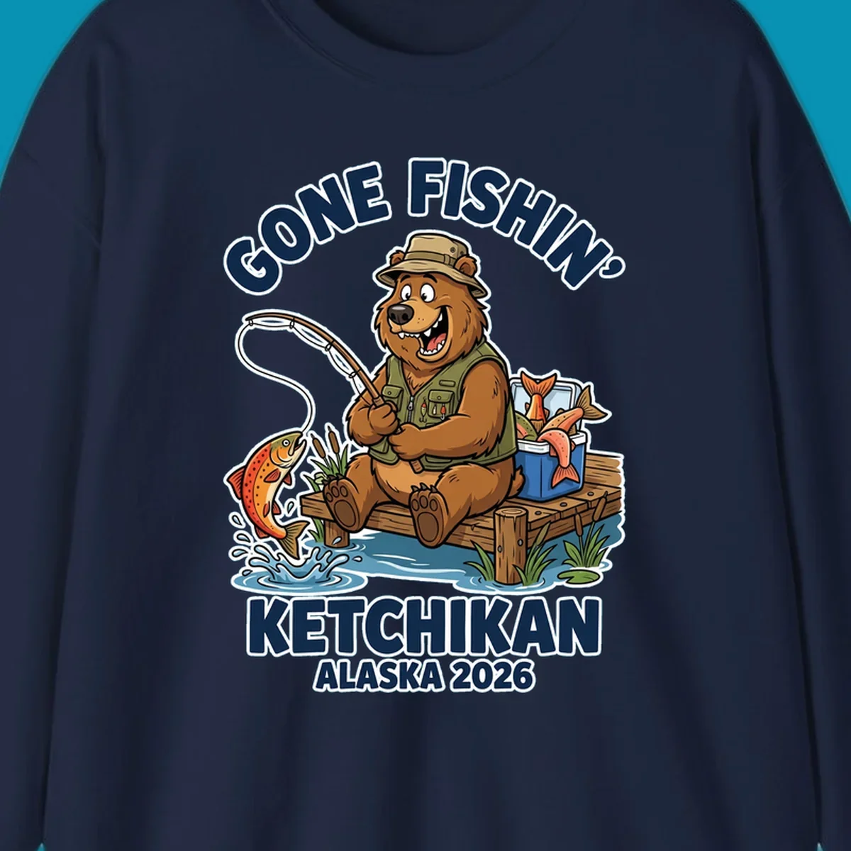 Cartoon bear in hat and vest fishing from a dock, with a fish on the line and cooler. Text: 'GONE FISHIN' KETCHIKAN ALASKA 2026'. Ideal for a gone-fishin-ketchikan-bear themed Alaska cruise.