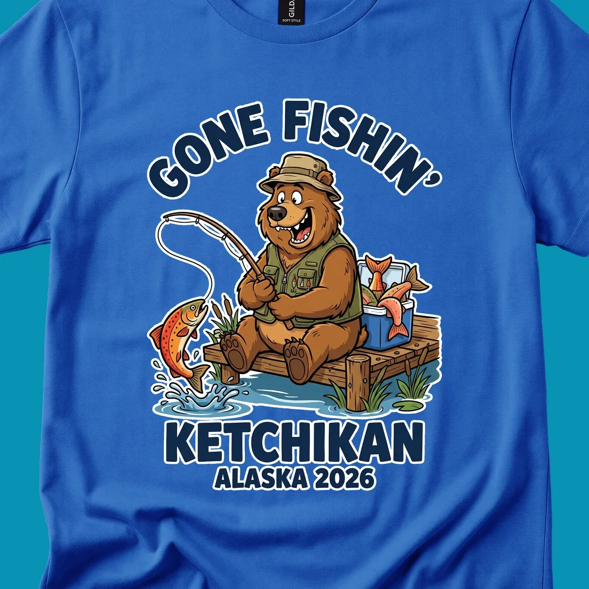 Cartoon bear in hat and vest fishing from a dock, with a fish on the line and cooler. Text: 'GONE FISHIN' KETCHIKAN ALASKA 2026'. Ideal for a gone-fishin-ketchikan-bear themed Alaska cruise.