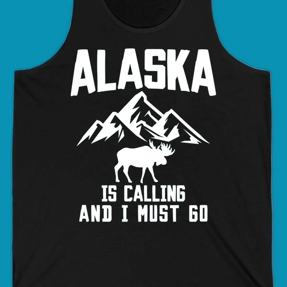 White moose silhouette and snow-capped mountains with text reading Alaska is calling and I must go