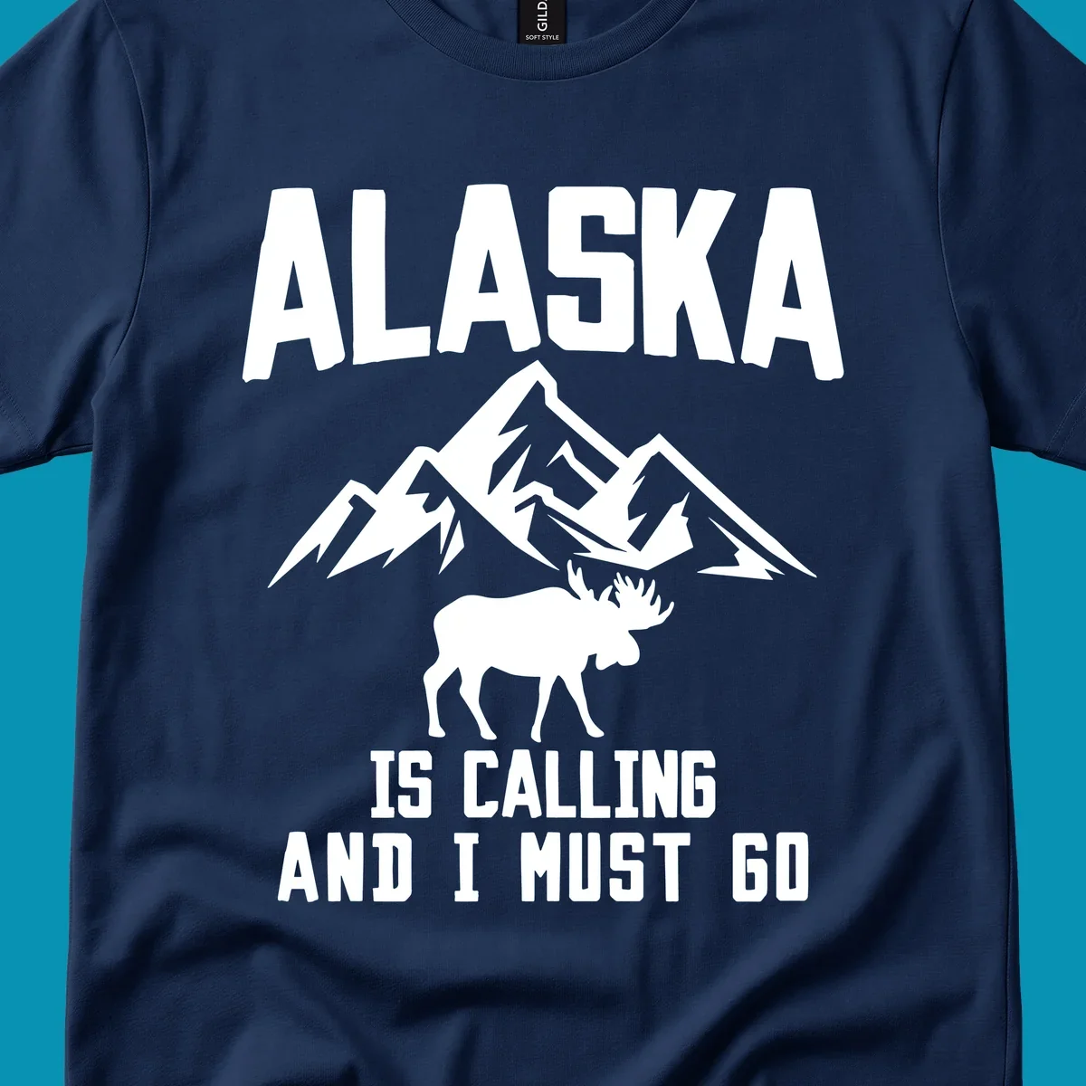 White moose silhouette and snow-capped mountains with text reading Alaska is calling and I must go