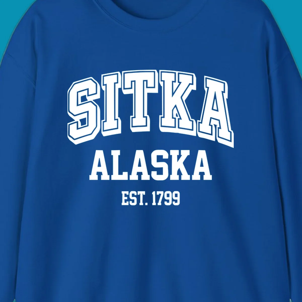 Vintage badge design reading Sitka Alaska Est. 1799 in bold outlined and solid white lettering on gray background