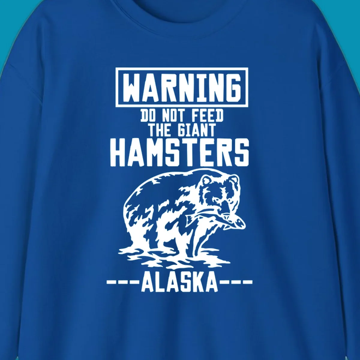 Warning-style design with giant hamster illustration and text reading 'Do Not Feed The Giant Hamsters Alaska' in white lettering on gray background