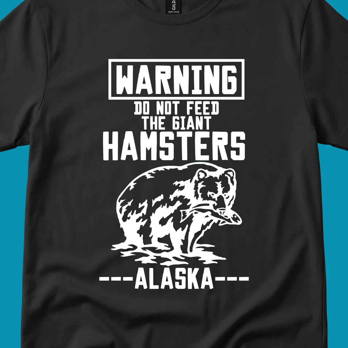 Warning-style design with giant hamster illustration and text reading 'Do Not Feed The Giant Hamsters Alaska' in white lettering on gray background