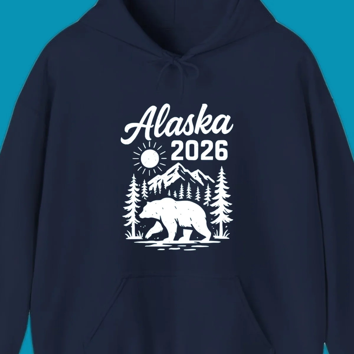 Alaska 2026 design featuring a polar bear walking through snowy mountains surrounded by evergreen trees and bright sun