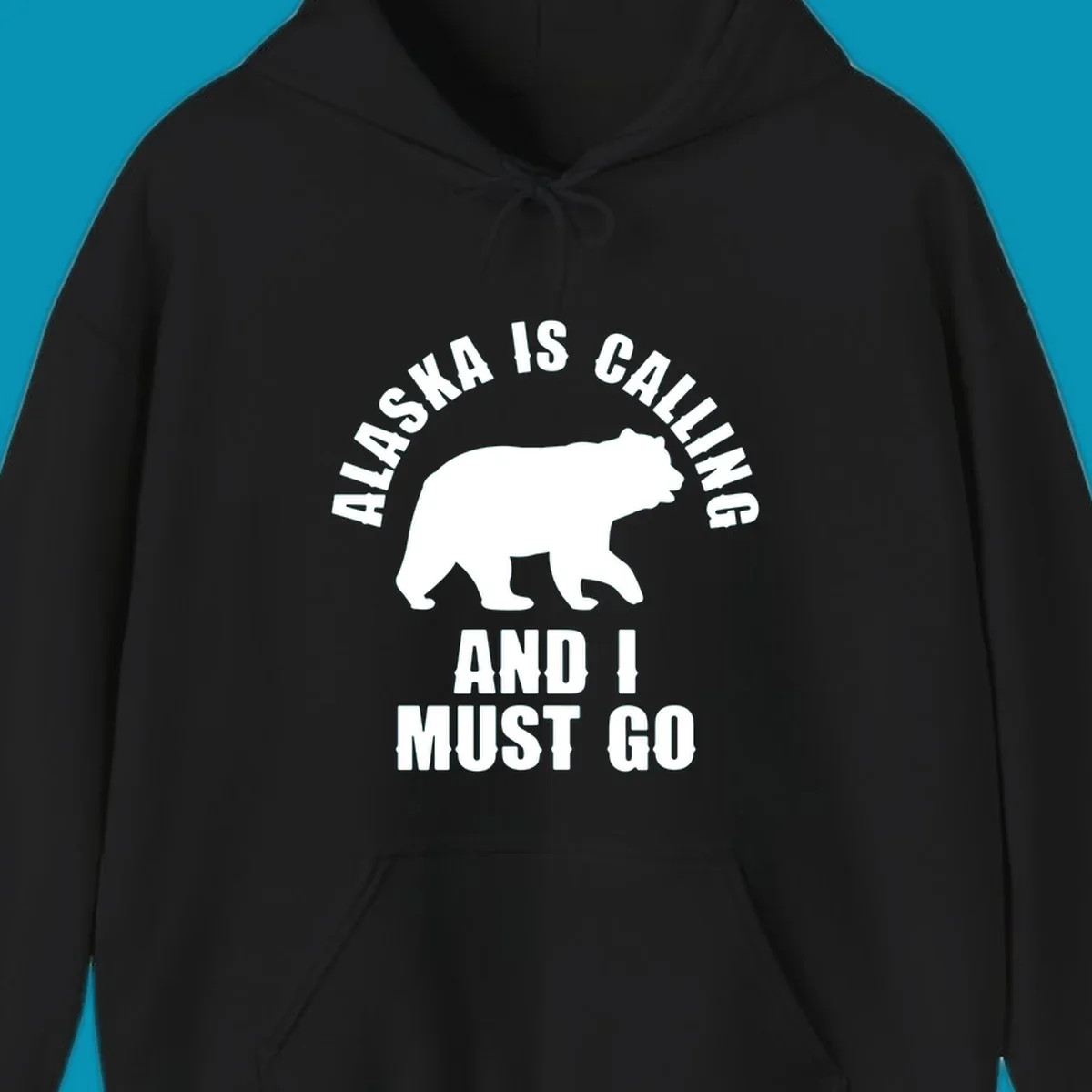 White bear silhouette with curved text reading 'Alaska is calling and I must go' on gray background