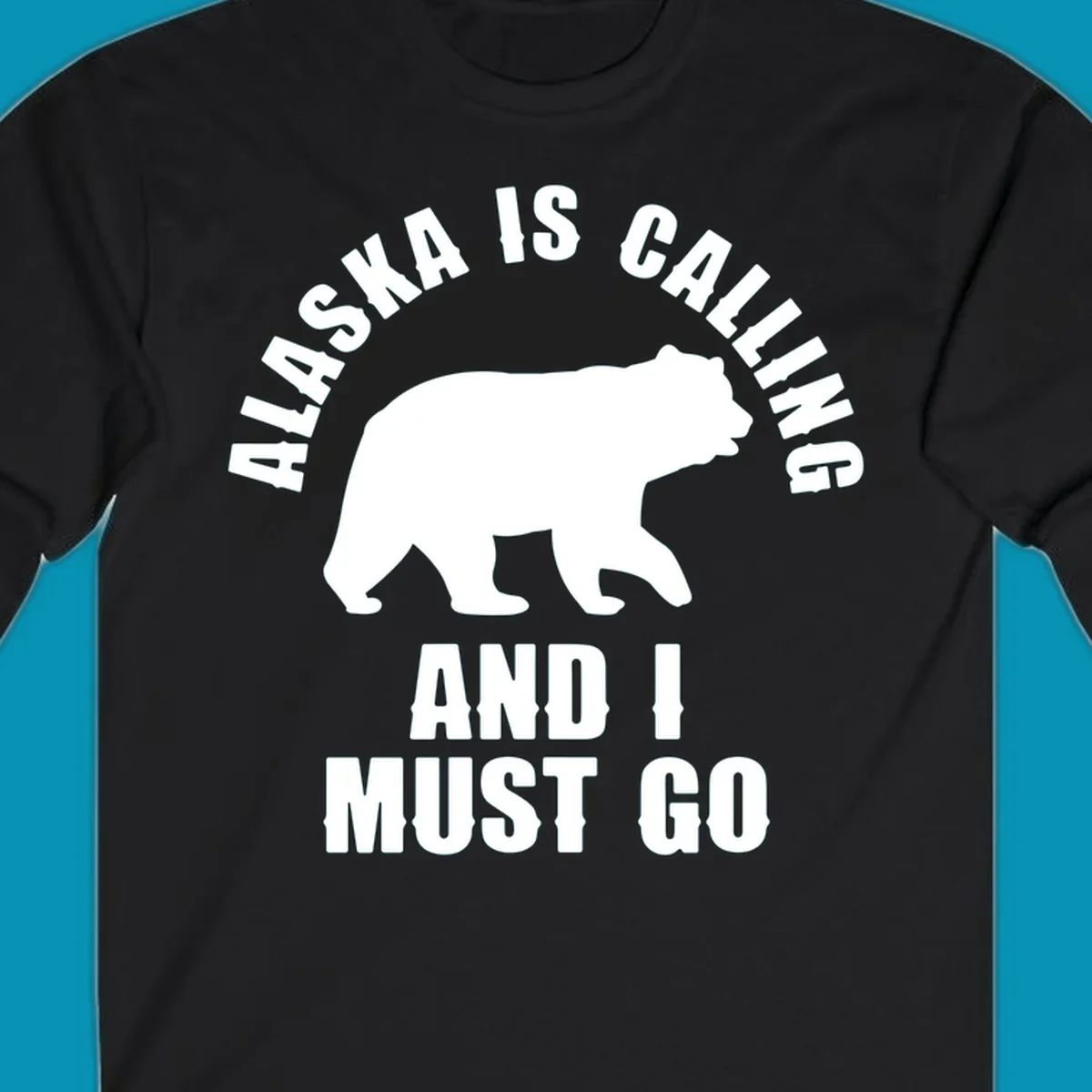 White bear silhouette with curved text reading 'Alaska is calling and I must go' on gray background