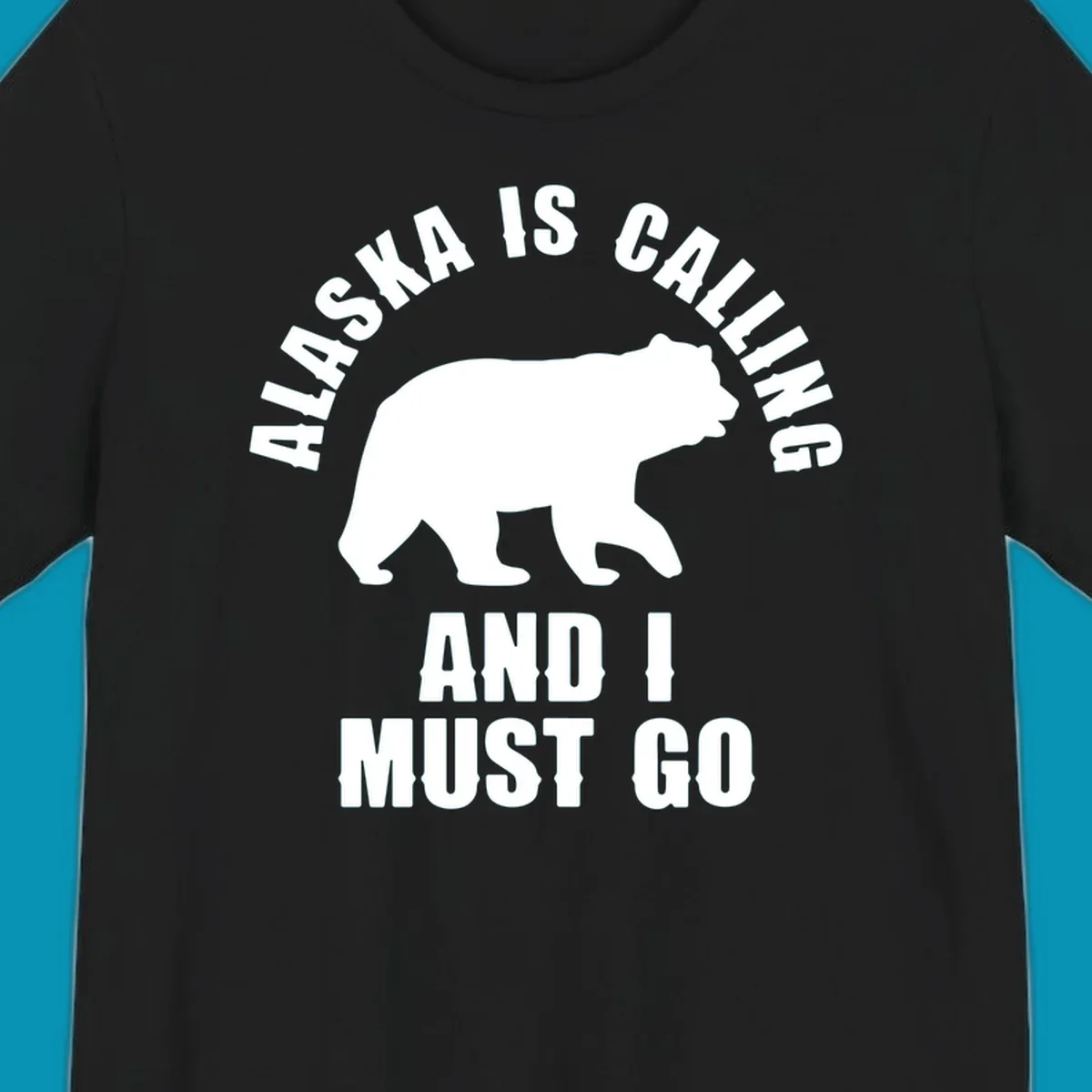 White bear silhouette with curved text reading 'Alaska is calling and I must go' on gray background