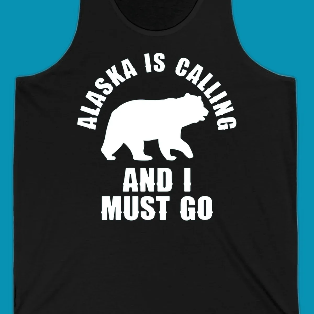 White bear silhouette with curved text reading 'Alaska is calling and I must go' on gray background