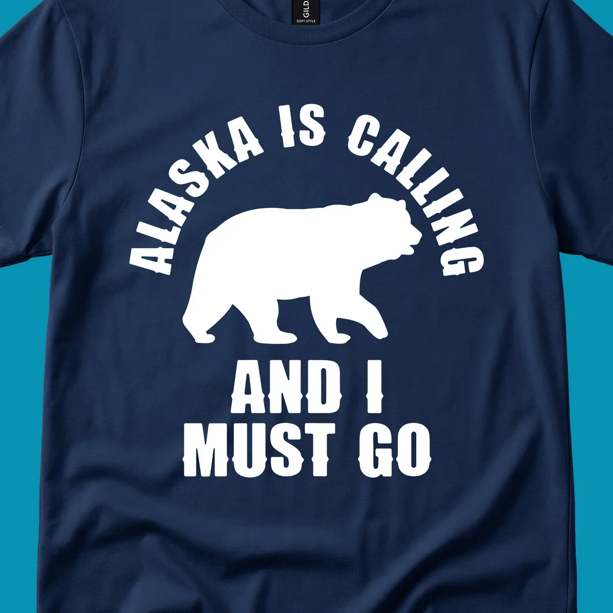White bear silhouette with curved text reading 'Alaska is calling and I must go' on gray background