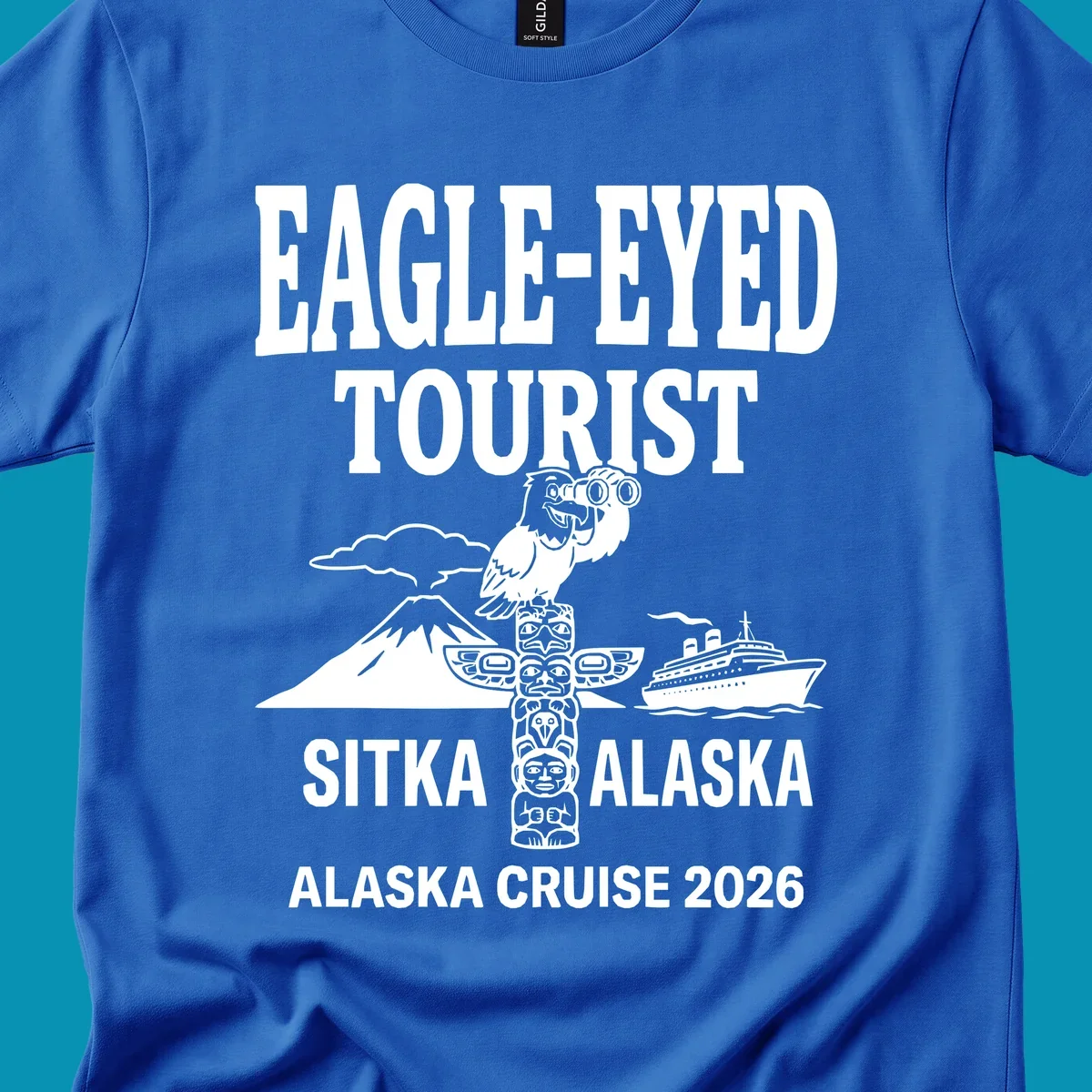 Eagle-eyed tourist design featuring a bald eagle with binoculars, snow mountain, totem pole, and cruise ship for Sitka Alaska 2026