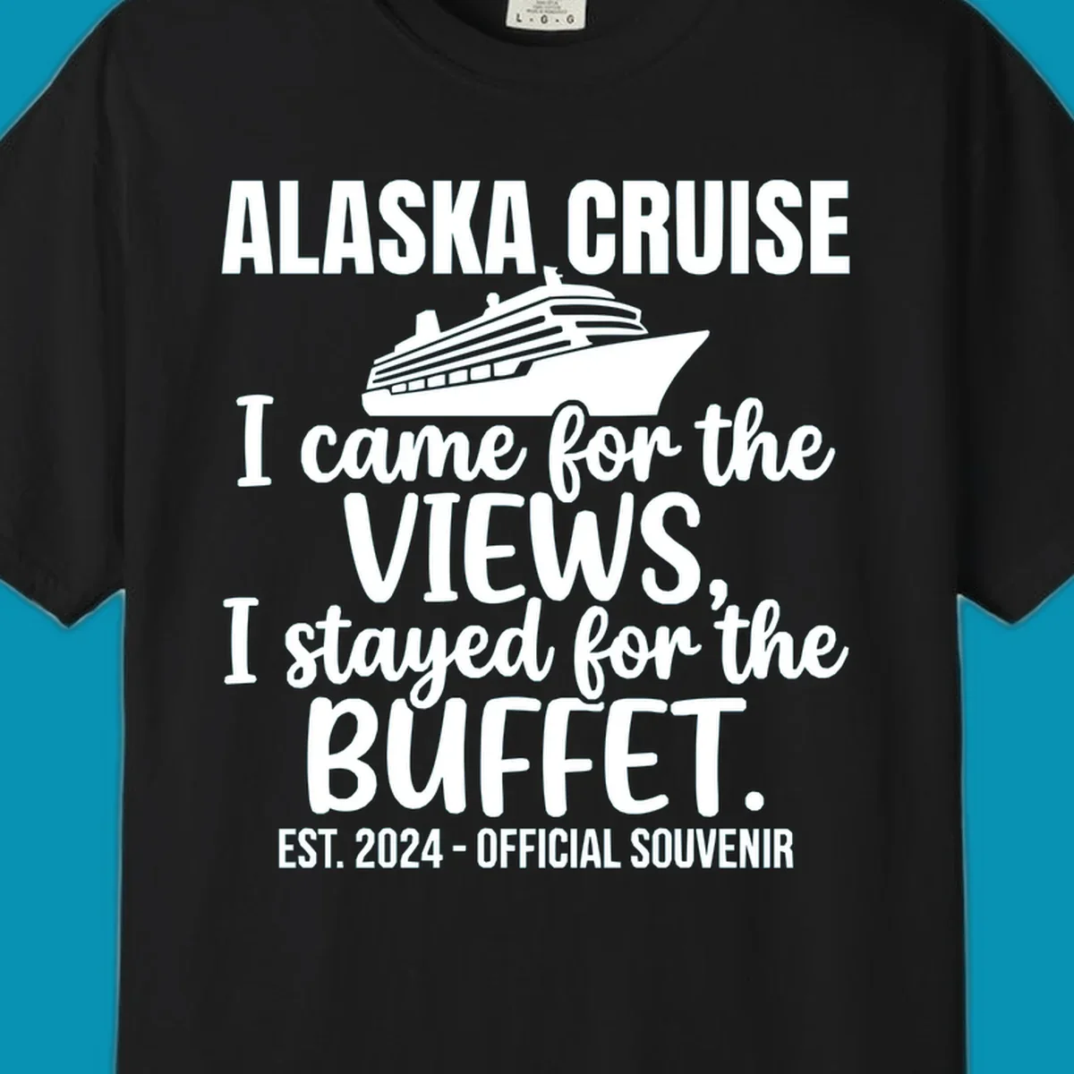 Gray t-shirt design with white cruise ship illustration and text reading 'I came for the views, I stayed for the buffet' — a funny Alaska cruise souvenir design