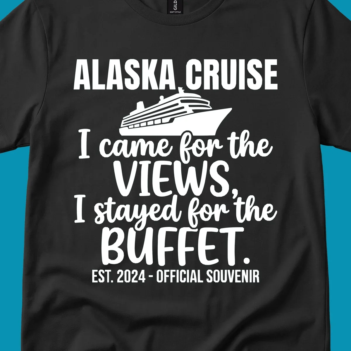 Gray t-shirt design with white cruise ship illustration and text reading 'I came for the views, I stayed for the buffet' — a funny Alaska cruise souvenir design