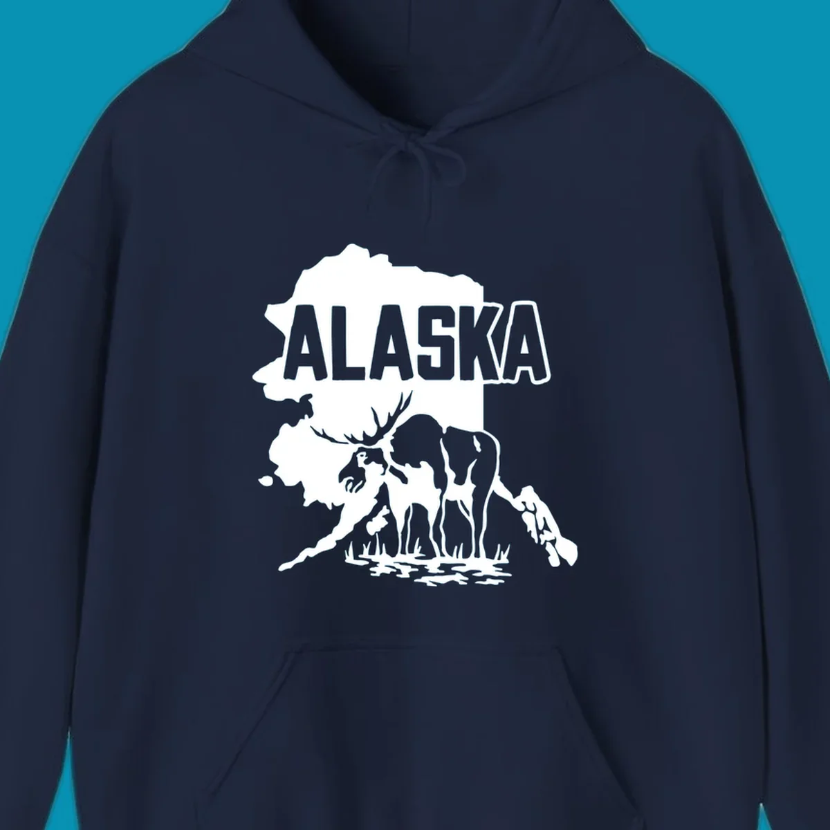Alaska state map silhouette filled with moose, bear, and eagle wildlife illustrations with grass and water landscape elements