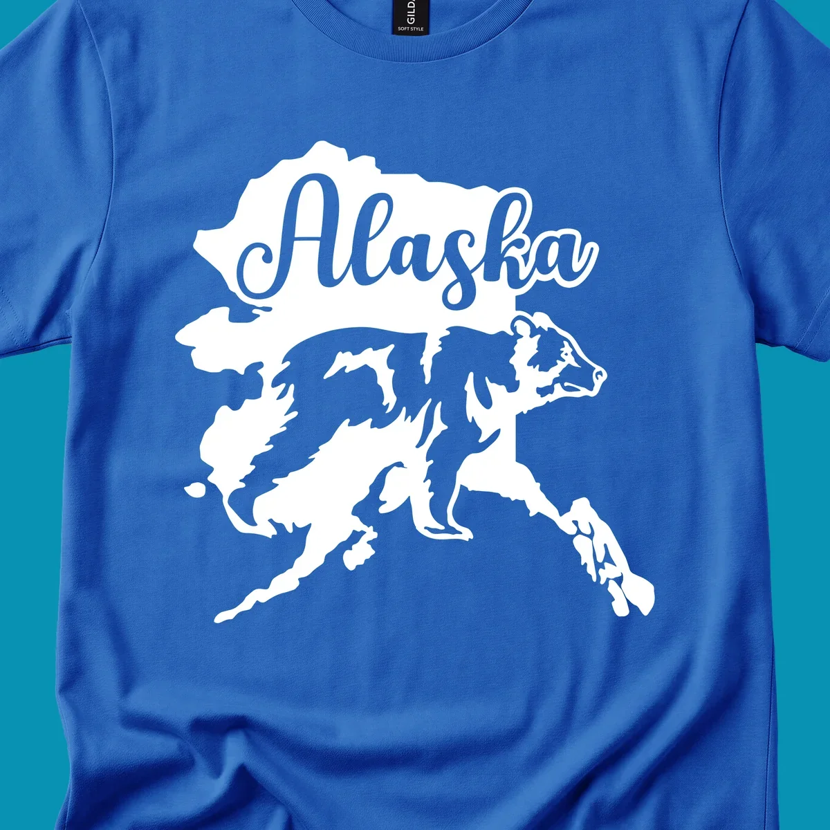 Alaska state map with bear silhouette and 'Alaska' text in elegant script lettering on gray background