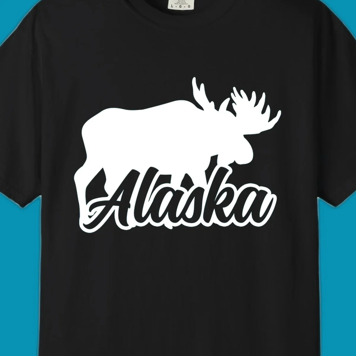 White moose silhouette with branching antlers above stylized 'Alaska' text in gray lettering on gray background