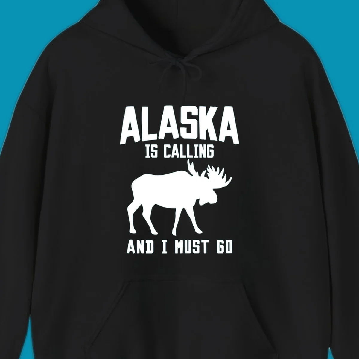 White moose silhouette with text 'Alaska Is Calling And I Must Go' on gray background—Alaska is calling moose design