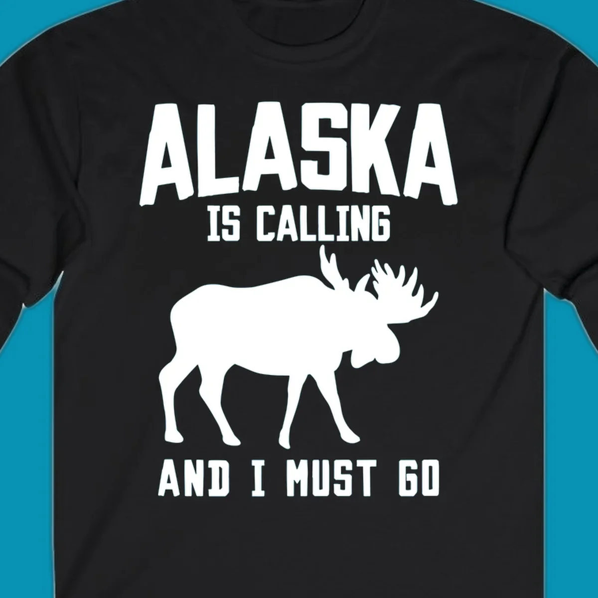 White moose silhouette with text 'Alaska Is Calling And I Must Go' on gray background—Alaska is calling moose design