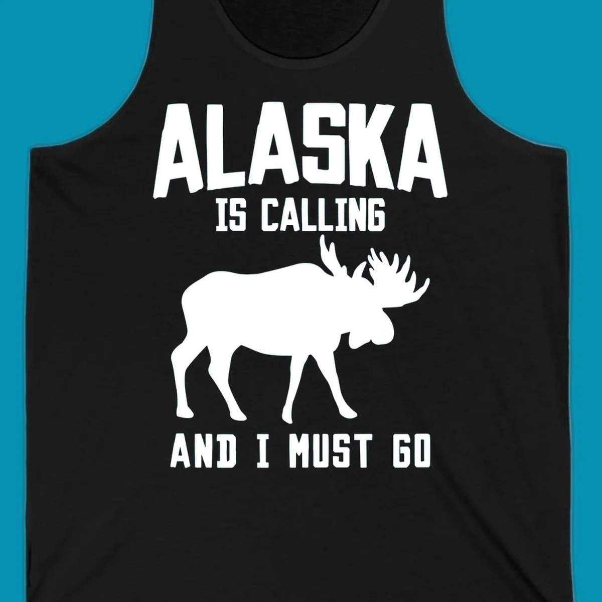 White moose silhouette with text 'Alaska Is Calling And I Must Go' on gray background—Alaska is calling moose design