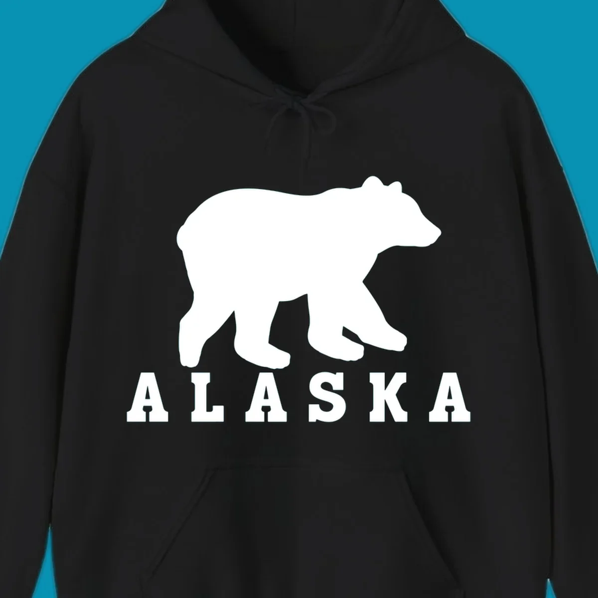 White bear silhouette standing with front paws visible, Alaska text below with pine tree accents on gray background