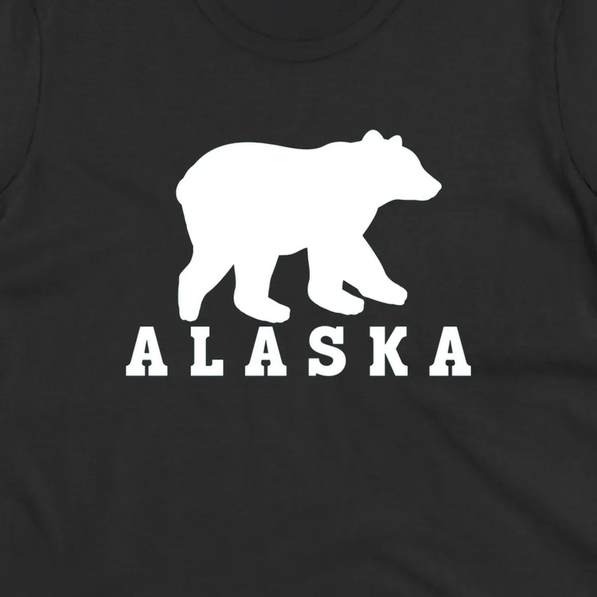 White bear silhouette standing with front paws visible, Alaska text below with pine tree accents on gray background