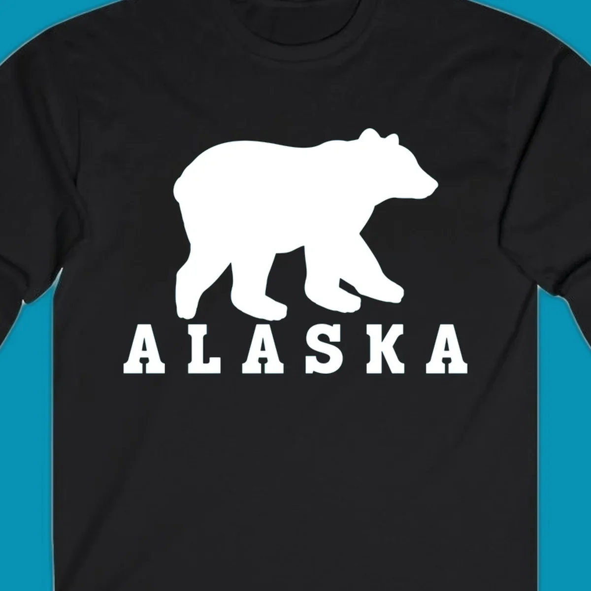 White bear silhouette standing with front paws visible, Alaska text below with pine tree accents on gray background