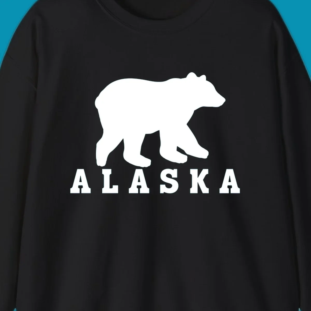 White bear silhouette standing with front paws visible, Alaska text below with pine tree accents on gray background