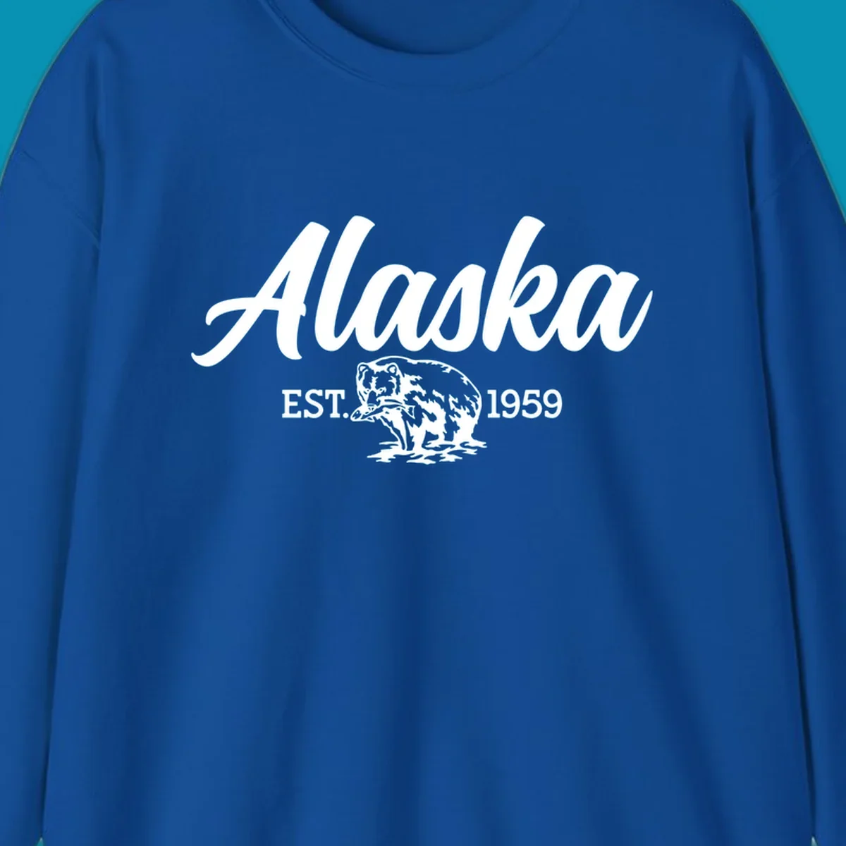 Vintage-style alaskan bear badge design with script lettering and established 1959 date on gray background