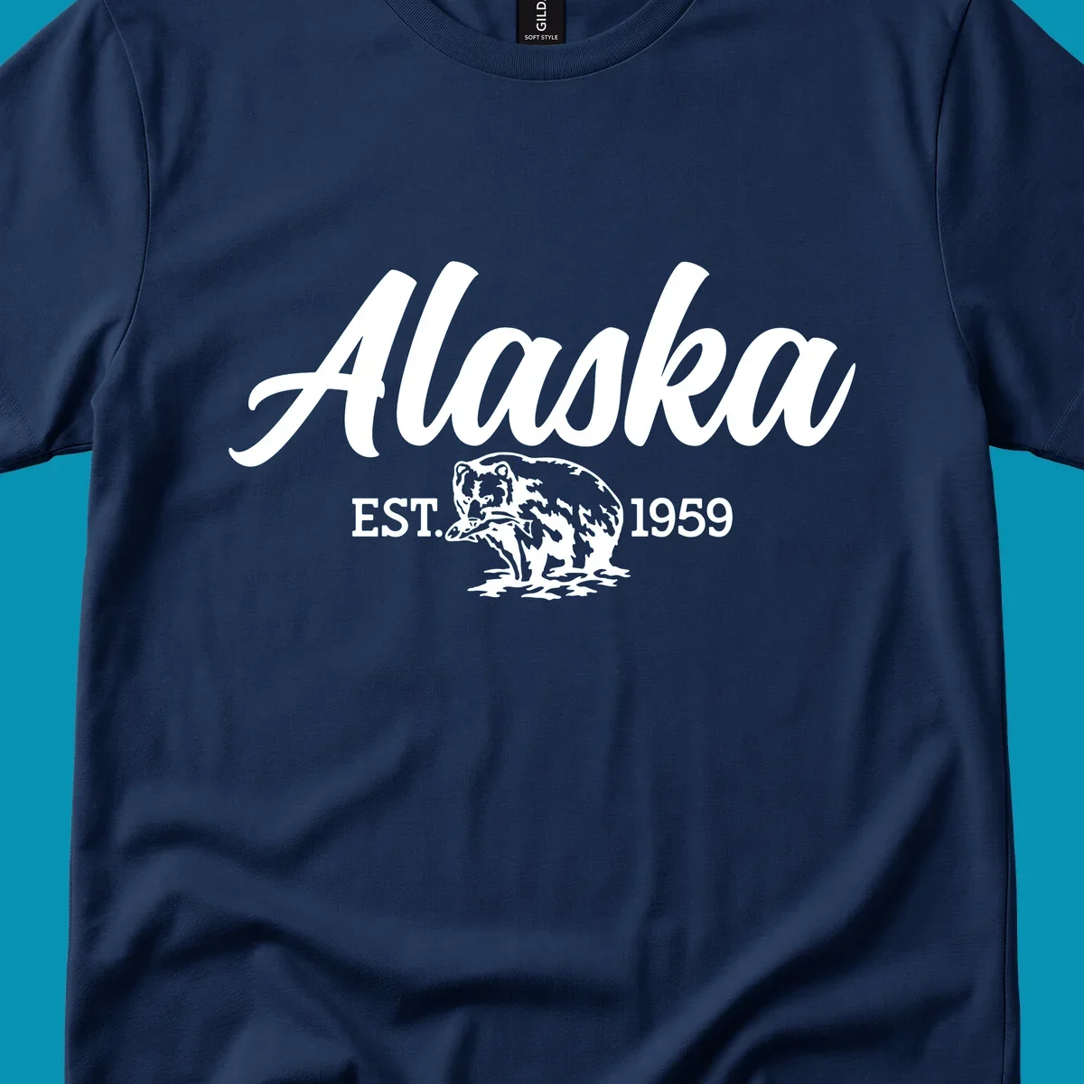 Vintage-style alaskan bear badge design with script lettering and established 1959 date on gray background