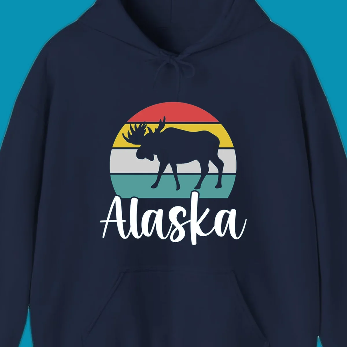 White moose silhouette against red, gold, gray, and teal horizontal stripes in a circular badge design representing Alaska mountains and wildlife.
