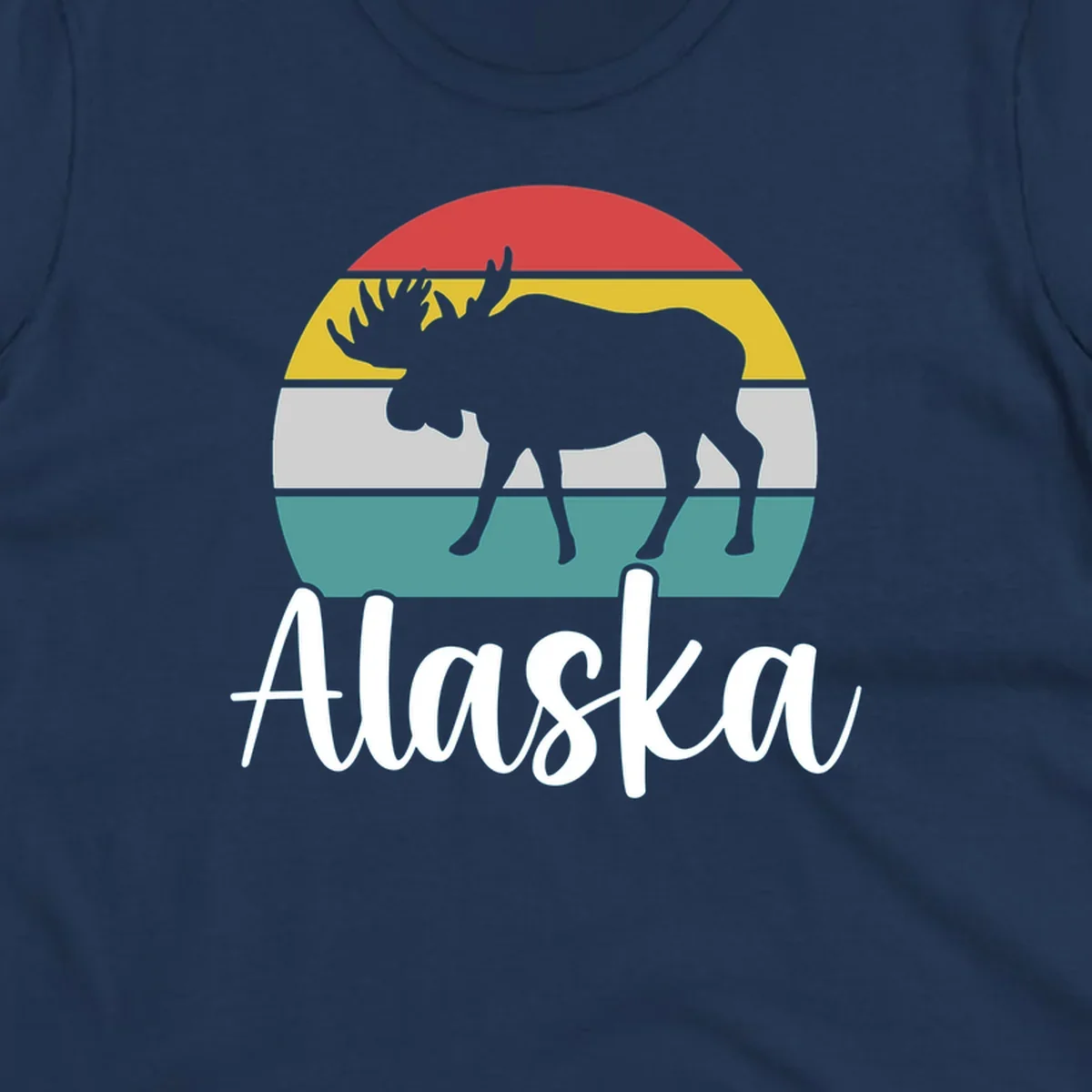 White moose silhouette against red, gold, gray, and teal horizontal stripes in a circular badge design representing Alaska mountains and wildlife.